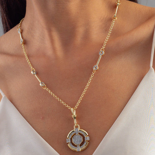 Gold necklace with a circular pendant worn by a person